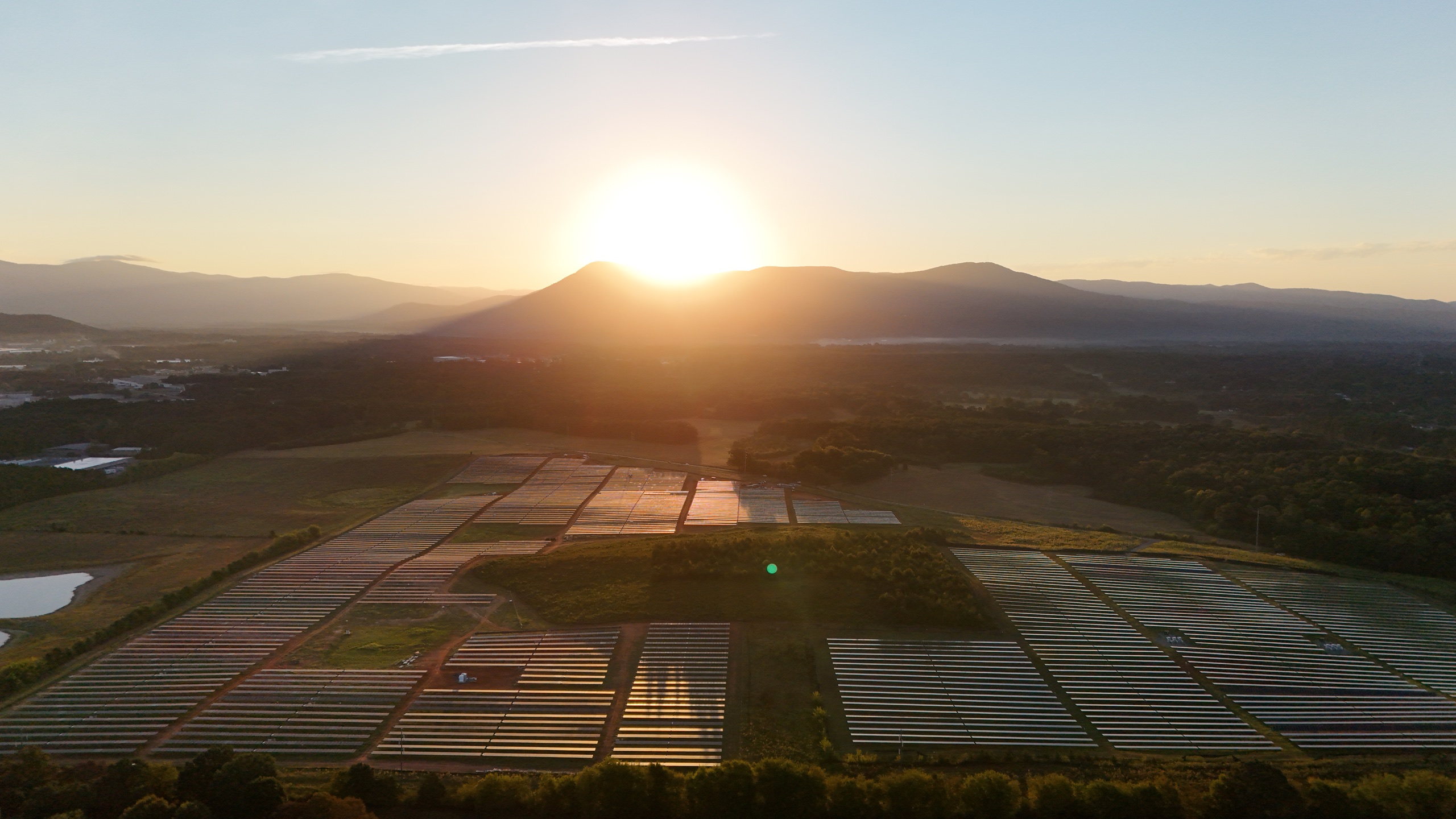 Sunrise above the mountains and solar arrays at Murray Treadwell