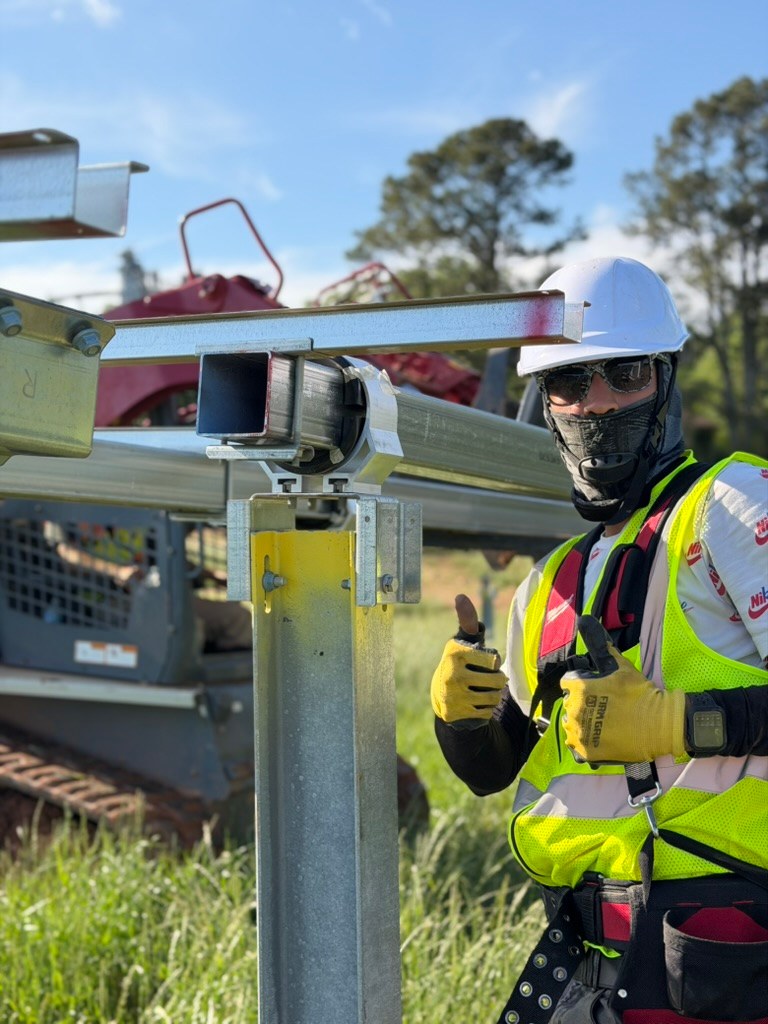 Jackson Bernal crew member beside installed racking