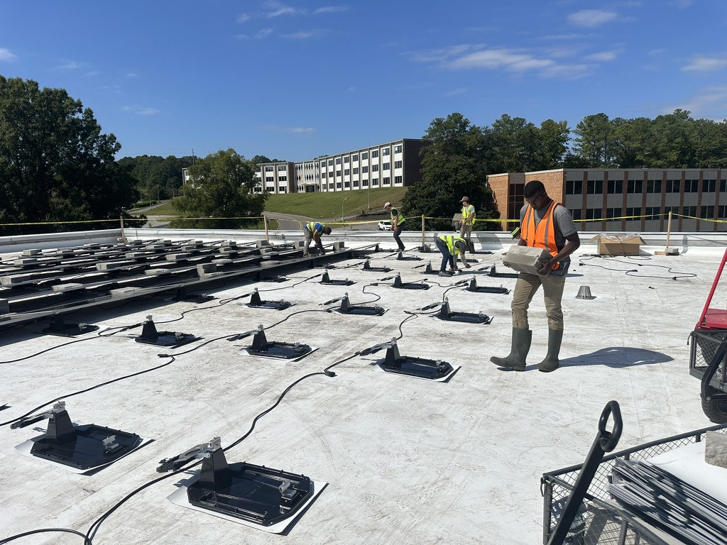 Crew installing rooftop solar mounts at Ladd Office Park
