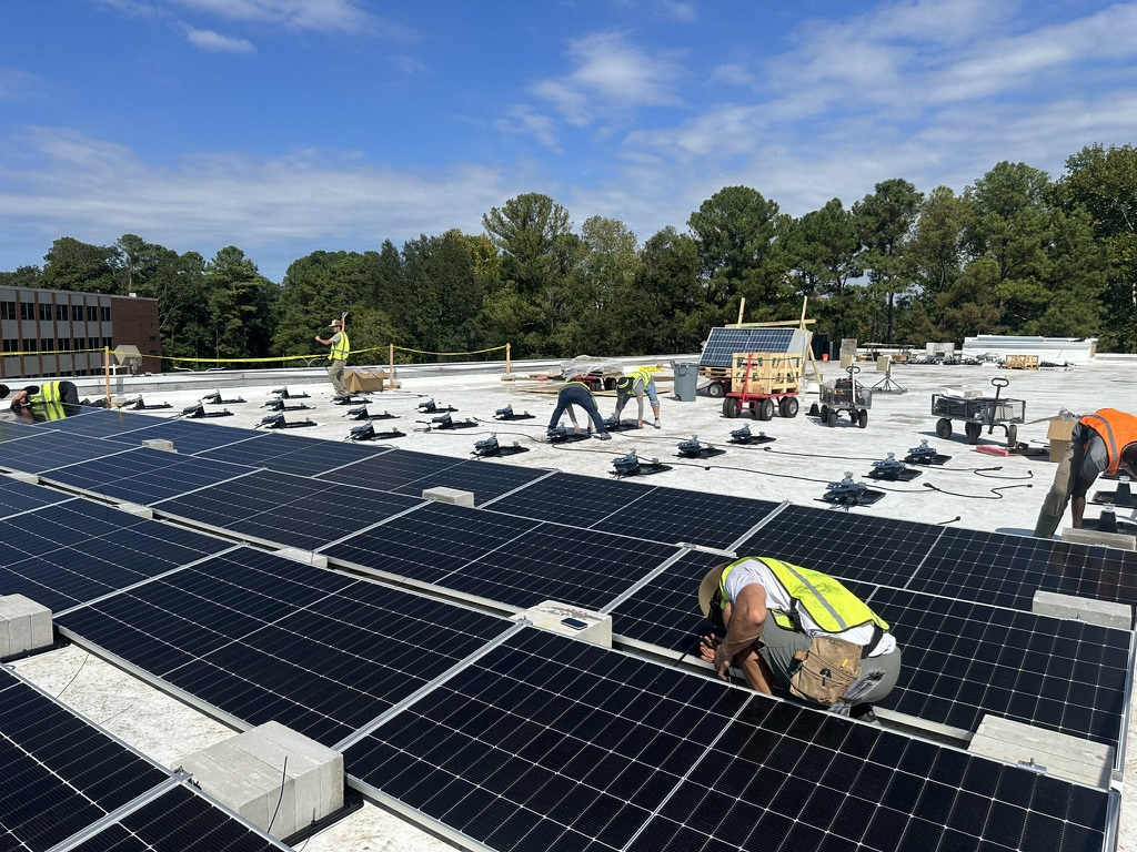Crew installing rooftop solar panels at Ladd Office Park