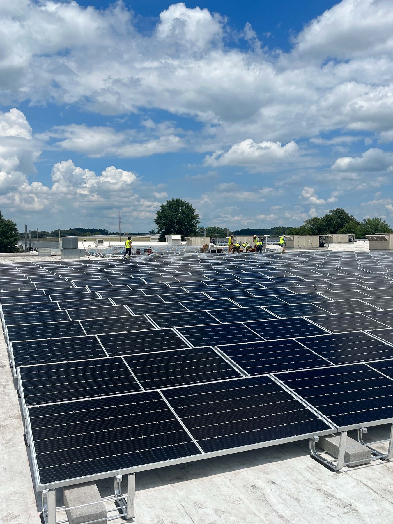 Crew installing rooftop solar modules at Mitchell Beverage