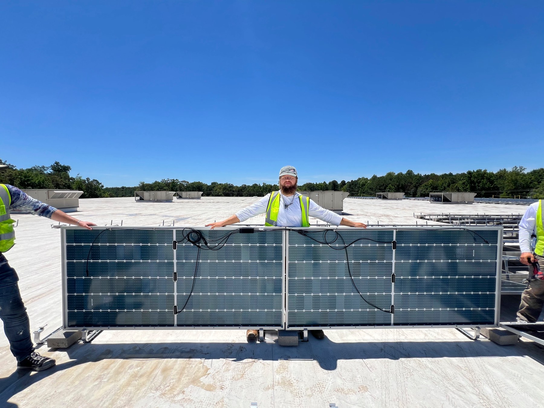 Mitchell Beverage crew positioning a solar module